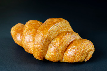 fresh croissant on dark background