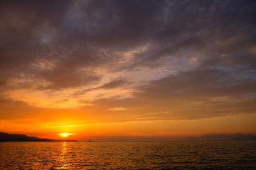 Naklejka na ściany i meble View of the sunset over Greece from Albania. The Ionian Sea.