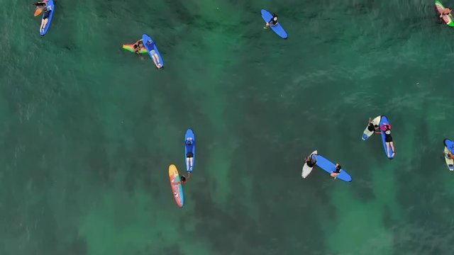 Tourists floating on rented surfboards during their holiday