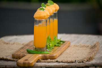 Pani Puri Shots : (a.k.a. golgappa shots or gol gappe shots) are a versatile snack invented in India made of stuffed pani puri (golgappa) placed on top of liquid-filled shot glasses. © Nitin