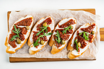 bruschetta with tomato, cream cheese and arugula