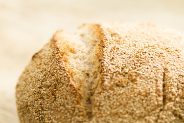 Closeup of a loaf of homemade bread with sesame seeds in selective focus