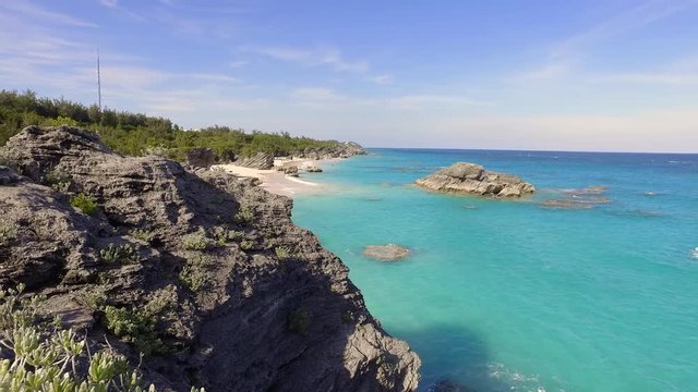 Pan Right to Left: Rocky Area of Hamilton Beach Bermuda on a Sunny Day in Hamilton, Bermuda