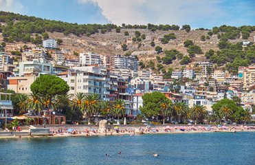  View of the city beach in summer in the holiday season. Saranda, Albania.