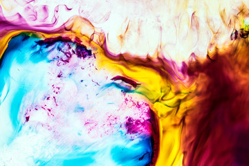 Background of red, pink, blue, yellow, brown ink waves