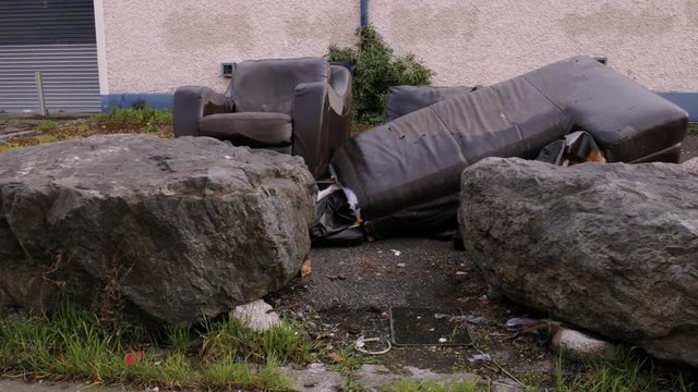 Garbage thrown out to the streets, illegal dumpster from old used broken furniture