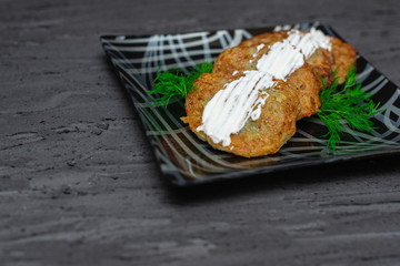 Potato pancakes with sour cream. Ukrainian Traditional Cuisine. Top view. Free space for your text.