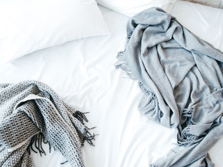 Morning awakening. New day beginning. Messy unmade bed. Cozy home textile in bedroom. Warmth and...