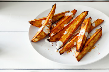 Homemade caramelized roasted sliced yams or sweet potato with Greek-style yogurt and crushed...