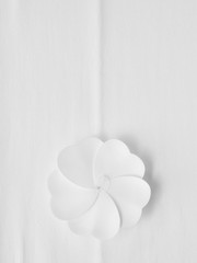 White artificial flower on white paper