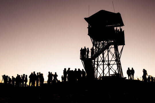 Poonhill view point tower in the morning before sunrise. Silhouettes of trekkers and lookout tower. Poon Hill, Himalayas, Nepal.