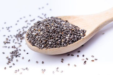 chia seeds in a wooden scoop isolated on white