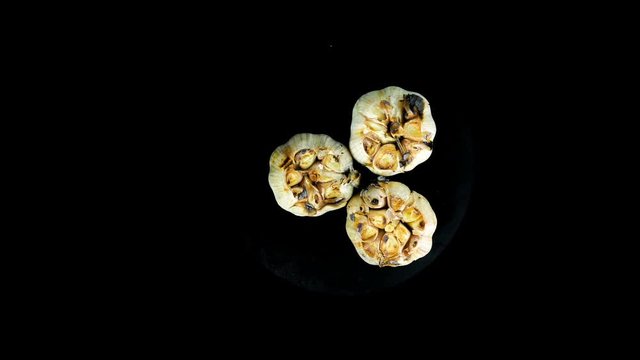 grilled garlic on black background.