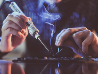 Soldering courses. Microelectronics engineering and technology concept. Technician or student...