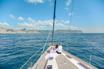 Fototapeta premium A Just married couple on yacht. Happy bride and groom on their wedding day