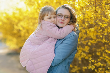 Mother and little daughter playing together in a park