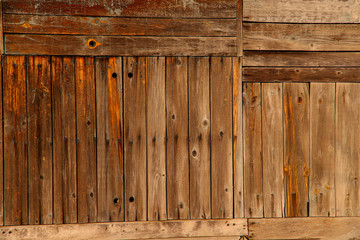 Background texture of an old wooden brown surface from boards. View from above, cropped shot, horizontal, close-up. Nature and construction concept