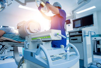 Spinal surgery. Group of surgeons in operating room with surgery equipment. Laminectomy