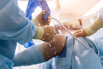 Arthroscope surgery. Orthopedic surgeons in teamwork in the operating room with modern arthroscopic...