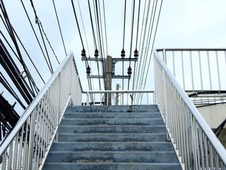Stairs overpass with electric pole in city
