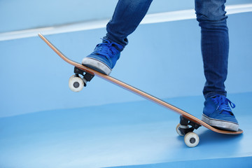 Fototapeta na wymiar skateboarding legs riding skateboard at skatepark