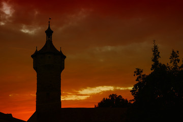 silhouette Klingen Tower in  Rothenburg ob der Tauber, Germany by night. Red sunset 