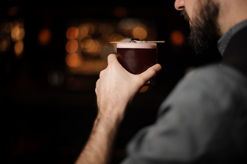 Close-up of bartender with an alcohol cocktail