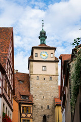 Fototapeta premium tower with clock and half timbered houses in Rothenburg ob der Tauber, Germany
