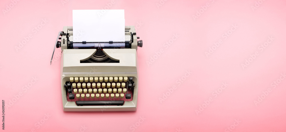 Fototapete top view of a typewriter from the 70s with blank paper for text, isolated on pink background.