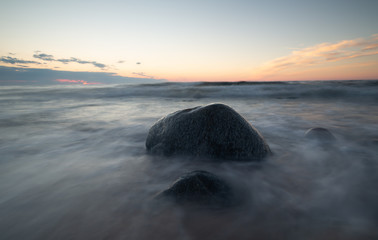 Sunset over the baltic sea with rocks in the water