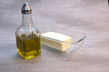 Bottle of olive oil and glassware with butter