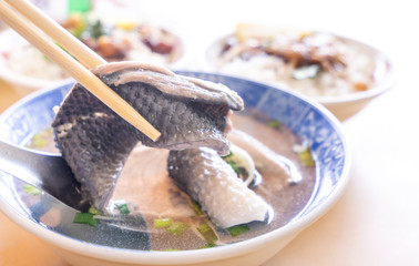 Milkfish skin soup, distinctive Taiwan delicacy food in Tainan. Famous meal set for lunch or breakfast with vegetable, top view, copy space, close up