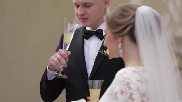 Newlyweds dring a champagne on wedding ceremony