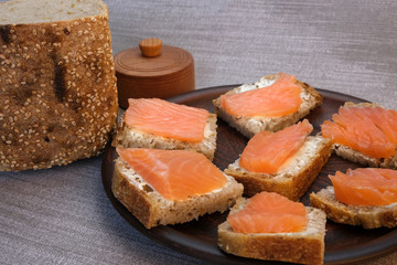 Small sandwiches on homemade bread with butter and red fish