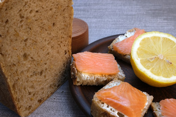 Small sandwiches on homemade bread with butter and red fish