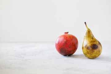 Trendy ugly organic fruits on the gray table with copy space for text. Horizontal orientation....