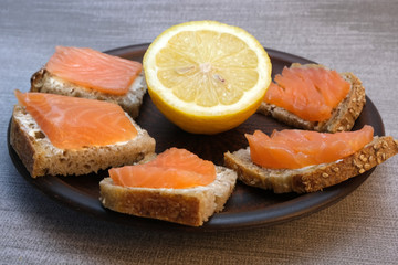 Small sandwiches on homemade bread with butter and red fish