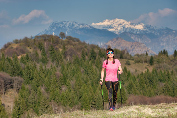 Naklejka premium Spring in the mountains between green and snow. A lonely girl during a trek