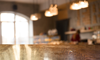 Empty wooden table in front of abstract blurred background of coffee shop . can be used for display or montage your products.Mock up for display of product