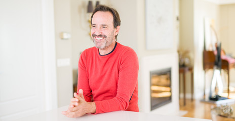 Fototapeta premium Handsome middle age man smiling looking at the camera at home