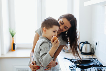 Healthy food at home. Happy family in the kitchen. Mother and child daughter are preparing eggs