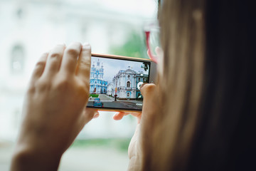 Saint Petersburg, RUSSIA - July 09, 2018: Tourists take pictures of the Smolnyi cathedral in St. Petersburg.