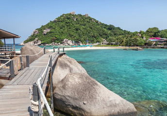 Landscape view of old wooden walkway bridge through the rock at Koh Nang Yuan Island under blue sky in summer day Koh Nang Yuan Island is most popular famous tourist attractions in the gulf of Thailan