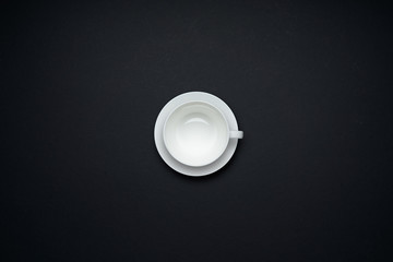 Empty coffee cup isolated on black background . Flat lay and top view with copy space .