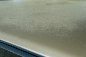 Close up of fading car paint colour on roof section. Car clear coat damage 