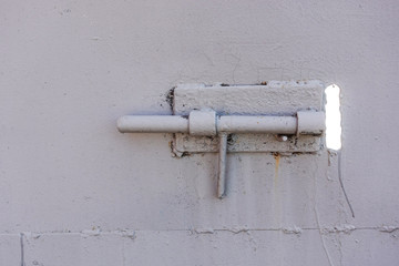 Close up of door locked with iron latch
