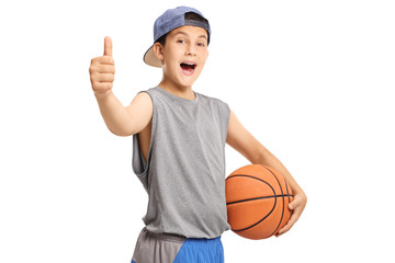 Cool teenage boy with a basketball showing thumbs up © Ljupco Smokovski