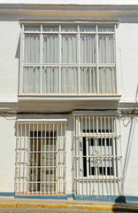 White house with iron bars typical architecture of San Fernando  town in the province of Cadiz Andalusia Spain
