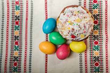 top view of decorated easter bread and dyed easter eggs