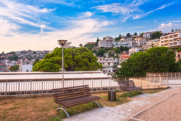 View of Ulcinj at sunset, beautiful mediterranean town, popular summer tourist resort in Montenegro, scenic travel background with park, urban architecture and blue cloudy sky